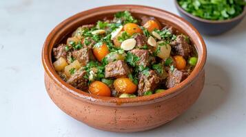 A brown bowl filled with meat and vegetables photo