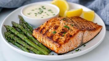 Grilled salmon with lemon and asparagus photo