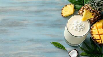 Pineapple smoothie with coconut and pineapple on a blue wooden background photo