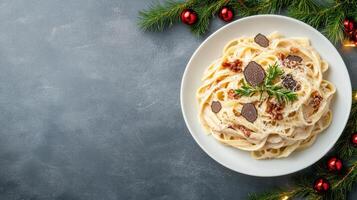 Christmas dinner with pasta and christmas tree on a gray background photo