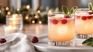Two glasses of lemonade with raspberries and mint leaves photo