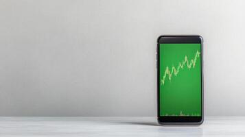 Smartphone with green screen showing stock market graph photo
