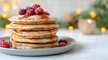 Pancakes with syrup and raspberries on a plate photo