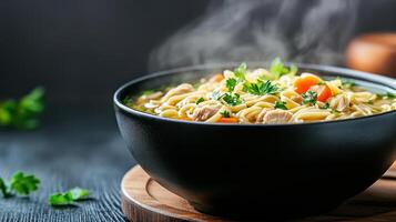 A bowl of noodles with vegetables and meat in it photo
