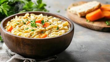 A bowl of pasta with carrots and parsley photo