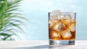 A glass of cola with ice and a leafy background photo
