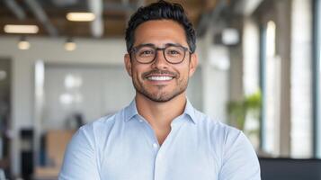 A man with glasses and a shirt smiling photo