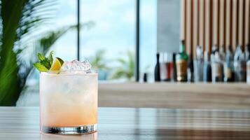 A cocktail sitting on a table in front of a window photo