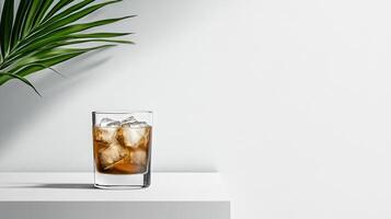 A glass of iced tea with a leaf on the side photo
