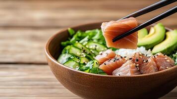 A bowl of sushi with chopsticks photo