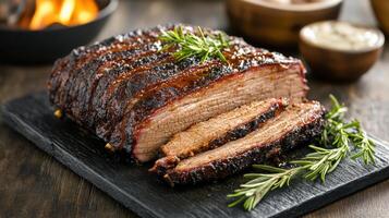 A barbecue with meat and herbs on a black board photo