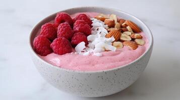 A bowl of smoothie with raspberries, almonds and coconut photo