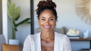 A woman with dreadlocks smiles at the camera photo