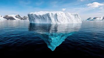 An iceberg floating in the ocean with mountains in the background photo