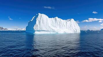Iceberg in the ocean with blue sky background photo