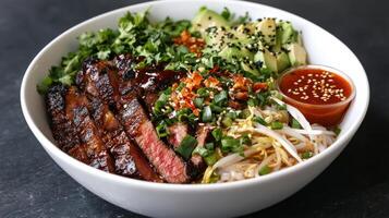 A bowl of steak and vegetables with sauce photo