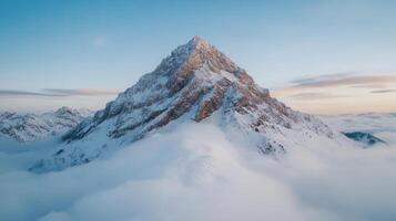 A mountain is seen in the clouds photo