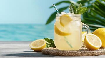 Lemonade in a jar with lemons on a wooden table photo