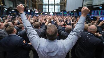 A man raising his arms in front of a crowd of people photo