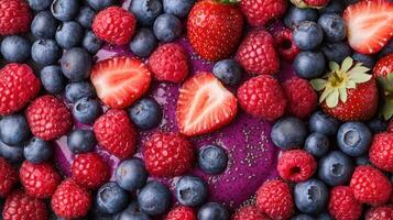 Berries and blueberries are scattered on a table photo