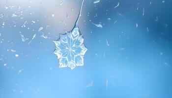 a snowflake hanging from a window with a blue sky in the background photo