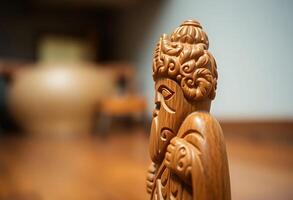 close up of a wooden statue on a table photo