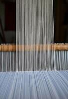 close up of a weaving machine with yarn photo
