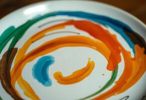 white plate with a colorful swirl painted on it photo
