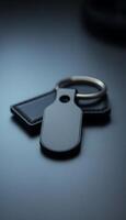 metal keychain with a black tag attached to it photo