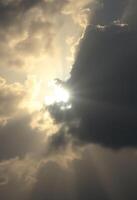 sun is shining through the clouds in the sky photo