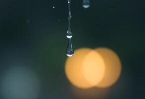 drop of water hanging from a faucet photo