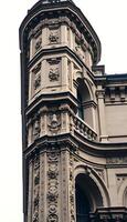 tall building with a clock on it's side photo