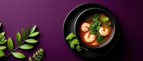 Elegant presentation of tom yam kung in black bowl modern kitchen food photography minimalist style photo