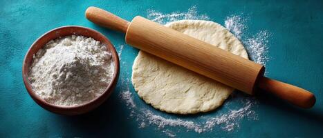 Rolling out flatbread dough with flour dusting in a culinary setting photo