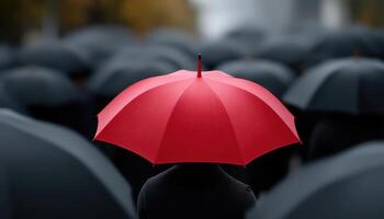 Red umbrella amidst a sea of black umbrellas urban street conceptual image gloomy atmosphere close-up isolation photo