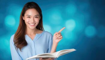 Engaging young asian female teacher pointing to open book in classroom setting photo