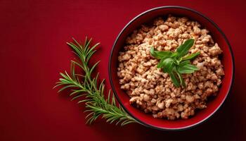 Fresh ground meat bowl on vibrant red background food presentation home kitchen top view culinary delight photo