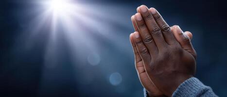 Prayerful hands in sunburst light spiritual reflection close-up photography tranquil environment photo