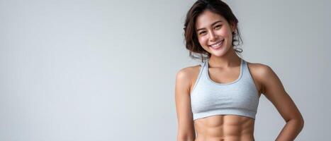 Fitness enthusiast asian woman posing in gym inspirational content bright environment eye-level view photo