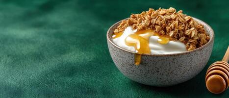 Delicious granola bowl with yogurt and honey minimalist style food photography green background photo