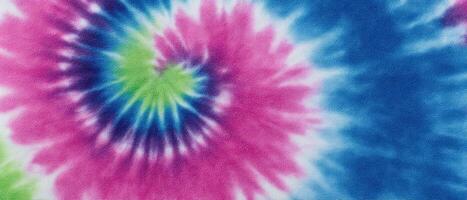 Vibrant tie-dye fabric close-up creative art colorful textiles studio setting artistic viewpoint photo