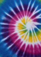 Vibrant tie-dye fabric closeup artistic display colorful patterns textile art bright environment photo