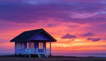 Vibrant sunset over a charming wooden house on stilts coastal beach photography serene atmosphere elevated view photo