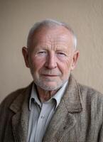 Elderly man wise gaze closeup portrait indoor setting natural light reflective emotions photo