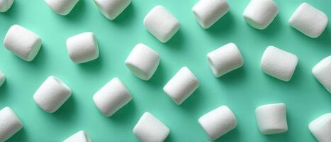 Delicate arrangement of white marshmallows on mint background food photography minimalist style photo