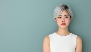 Elegant short-haired asian woman with fresh face studio setting portrait photography soft colors photo