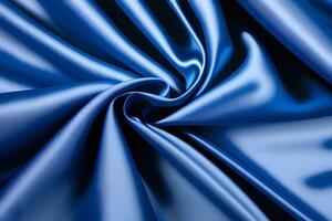 Abstract A mesmerizing texture of swirling blue satin fabric captivates the eye, showcasing the interplay of light and shadow. The flowing patterns create a sense of movement and elegance, invit photo