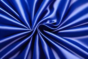 Royal blue satin drapes with a luxurious texture create an elegant backdrop, adorned with graceful swirls. This exquisite combination adds a touch of sophistication to any setting. photo