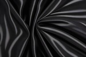Luxurious and captivating, the dark elegance of an abstract draped black satin fabric texture invites a sense of sophistication and mystery. Its rich, flowing design creates an atmosphere of refi photo