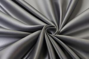 Experience the luxurious allure of elegant silver satin fabric, beautifully draped to create swirling patterns. Its smooth surface and rich texture make it the perfect backdrop for any setting. photo